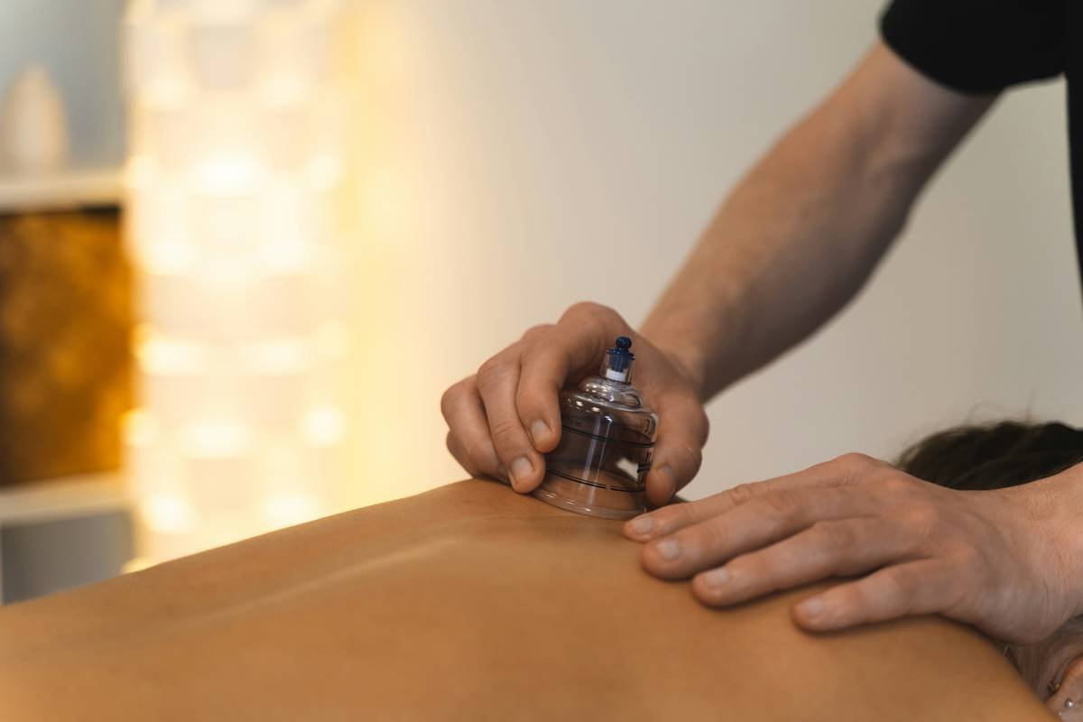 Diagram showing how wood therapy tools stimulate lymph flow and fascia in subcutaneous tissue